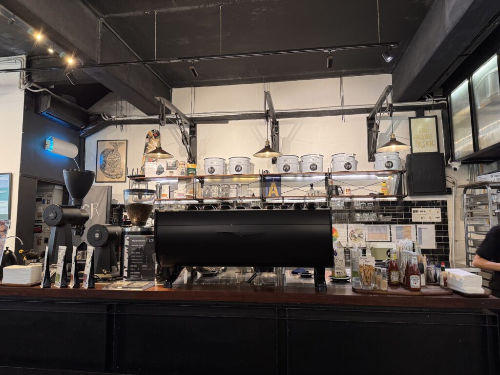 Industrial interior design of VCR Bangsar cafe with wood and black steel furniture.