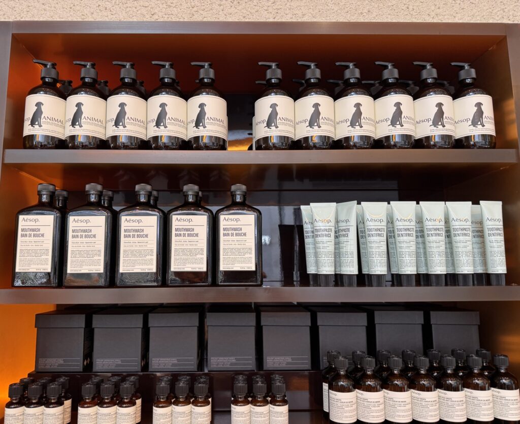 Aesop Toothpaste Dentifrice displayed on the second shelf at an Aesop store in Perth, alongside mouthwash and other personal care products.
