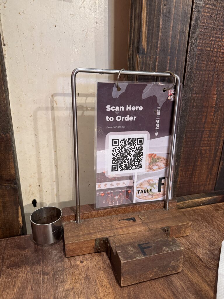 QR code stand for table ordering at Lai Foong Lala Noodles in Kuala Lumpur.