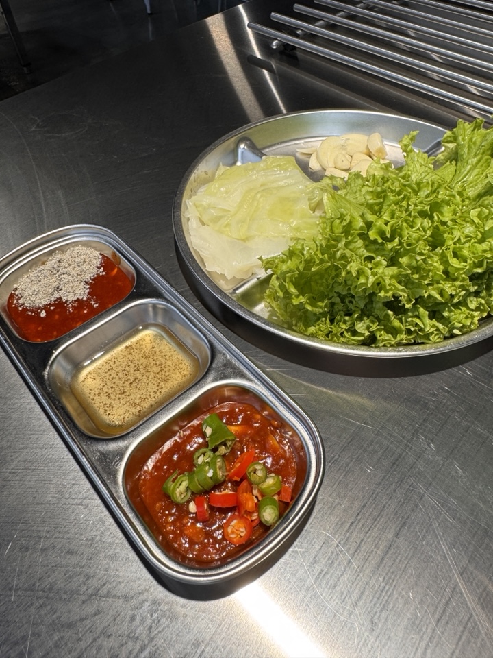 Korean BBQ dipping sauces including signature chili paste, ssamjang, and sesame oil salt.