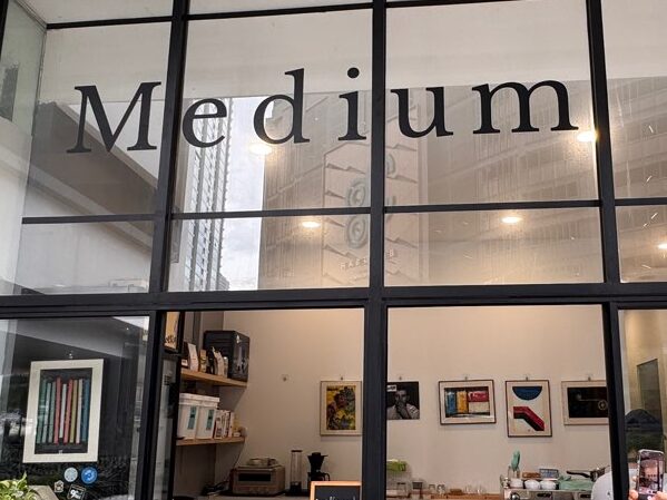 Exterior view of The Medium café in Bangsar, Kuala Lumpur, with the café name visible through a large glass window.