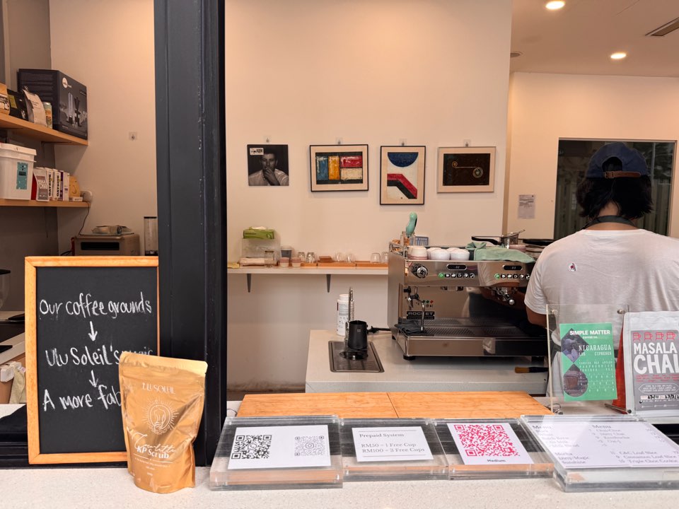 Interior of The Medium café showing the coffee counter, espresso machine, and simple interior design.