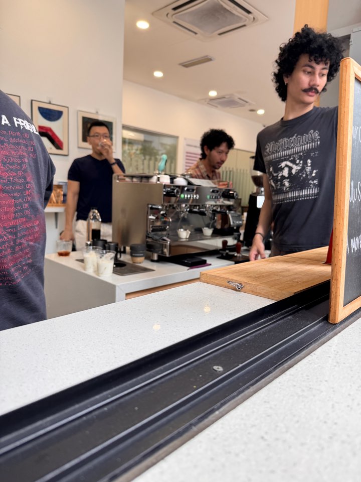Baristas working behind the counter at The Medium café in Bangsar.