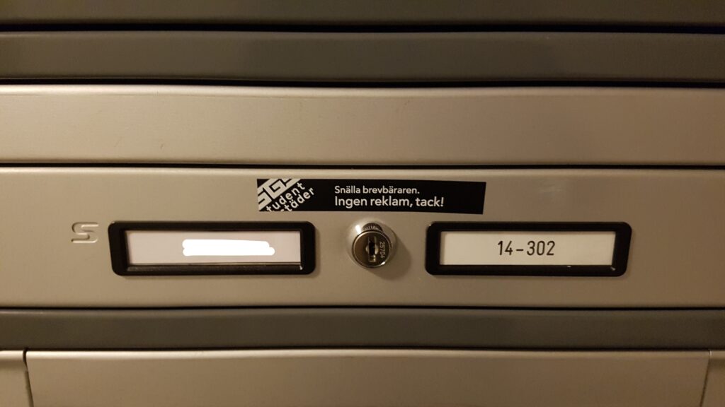 Personal mailbox with Swedish no ads sticker in student apartment