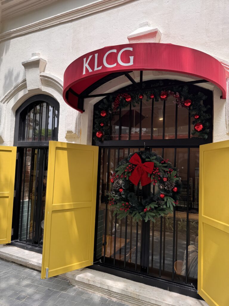 Exterior of KLCG Confectionery & Bakery in Kuala Lumpur with yellow doors and red signage.