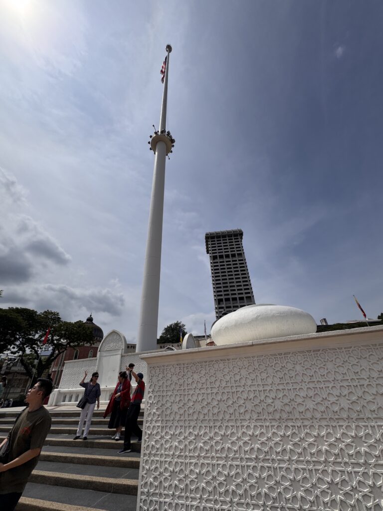 Tall flagpole at Merdeka Square in Kuala Lumpur with surrounding historic architecture.