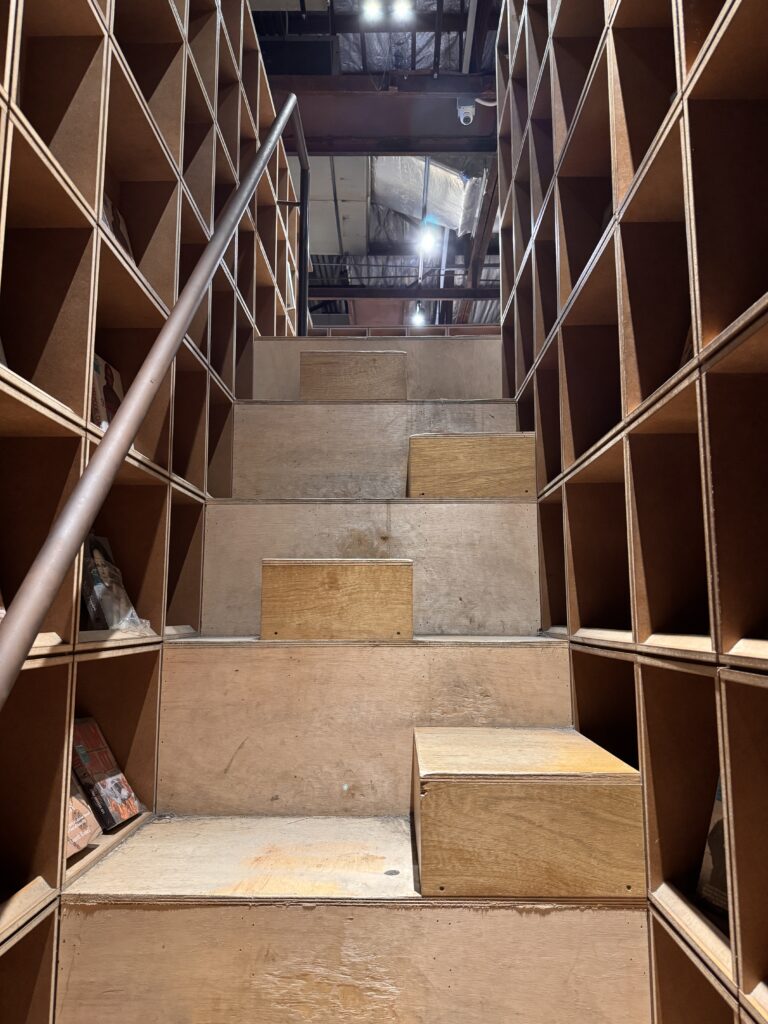 Staircase bookshelves inside BookXcess bookstore at REXKL with books lining the walls