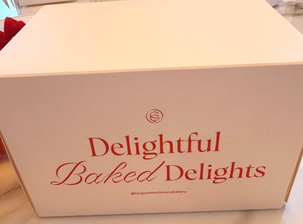 White takeaway box from KLCG Confectionery & Bakery with red logo.