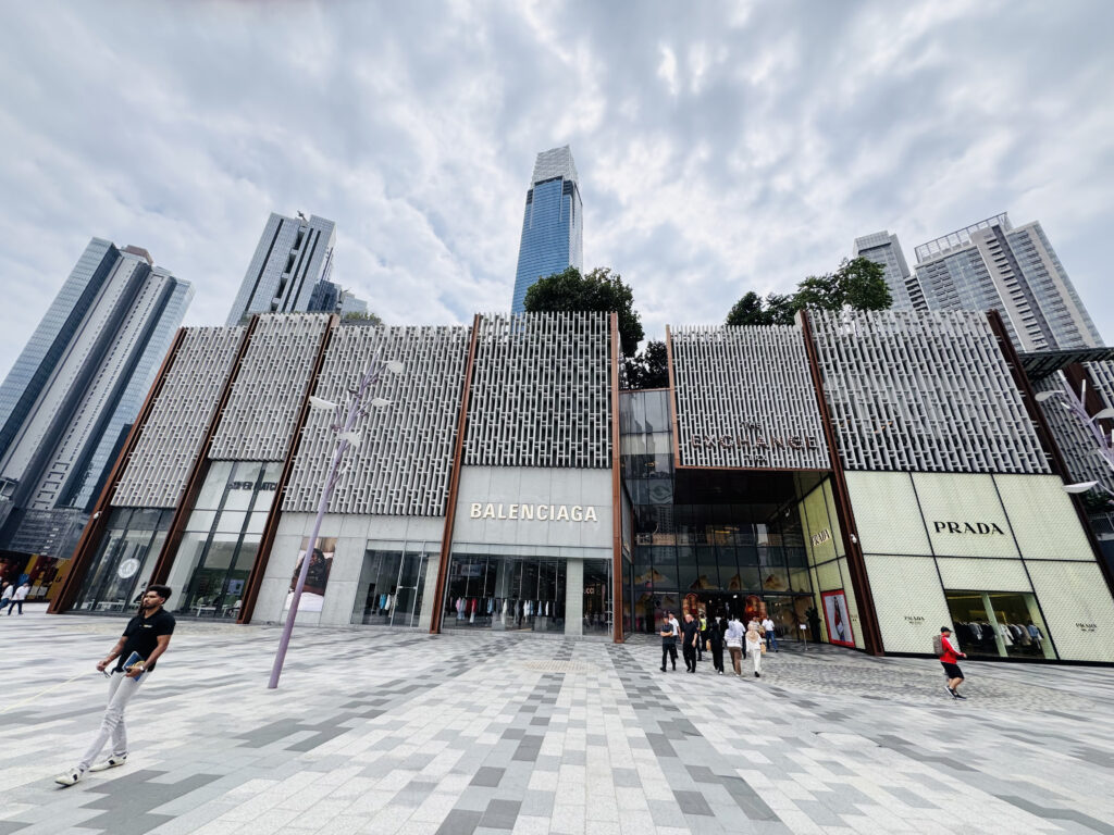Exterior view of TRX Mall in Kuala Lumpur with luxury brand storefronts and surrounding skyscrapers