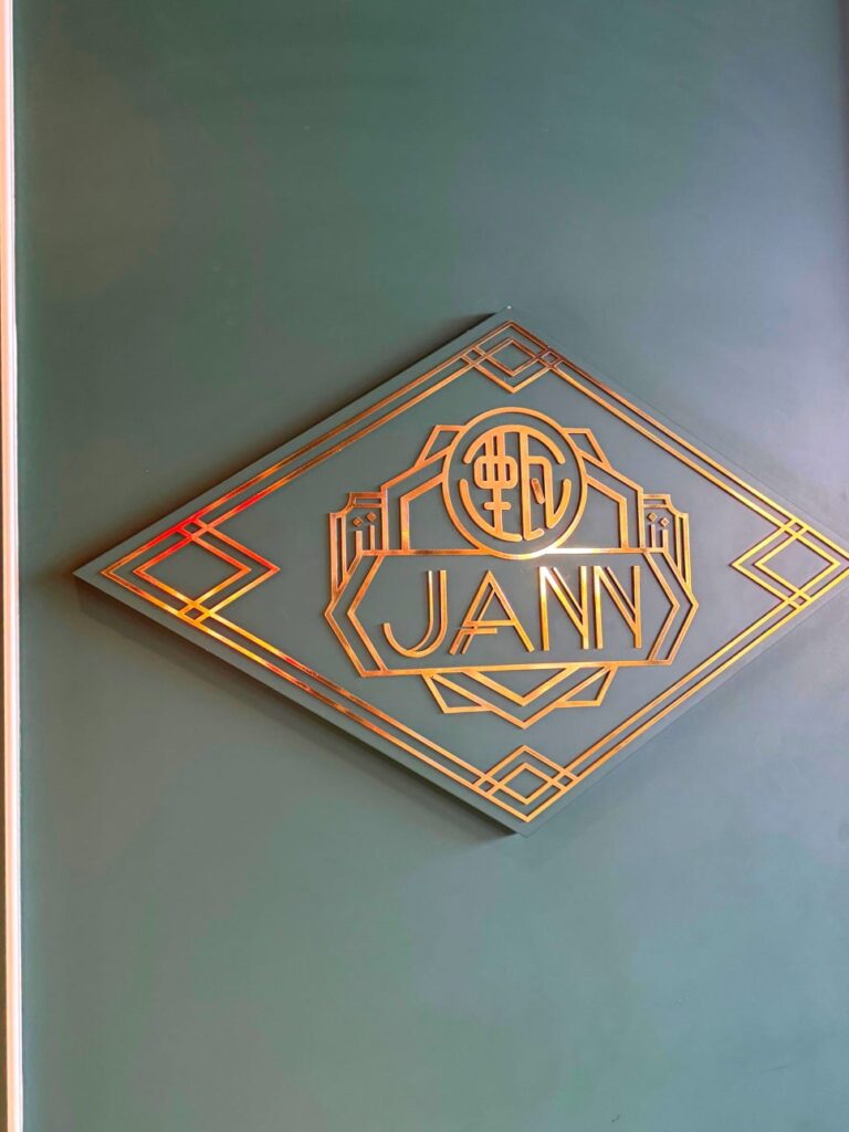 Dark green and gold JANN bar signboard at the entrance of Four Points by Sheraton Chinatown.