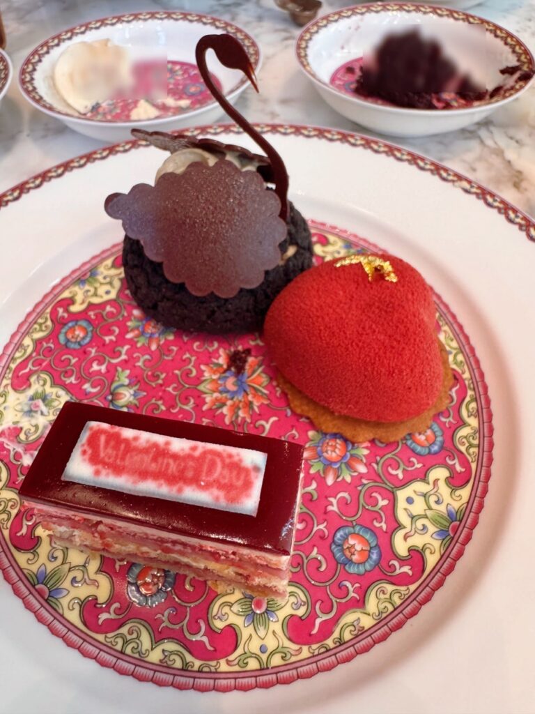 Dessert plate with black sesame mousse cake, crane-shaped choux pastry, and other sweets at Lady Yi’s Tea House.