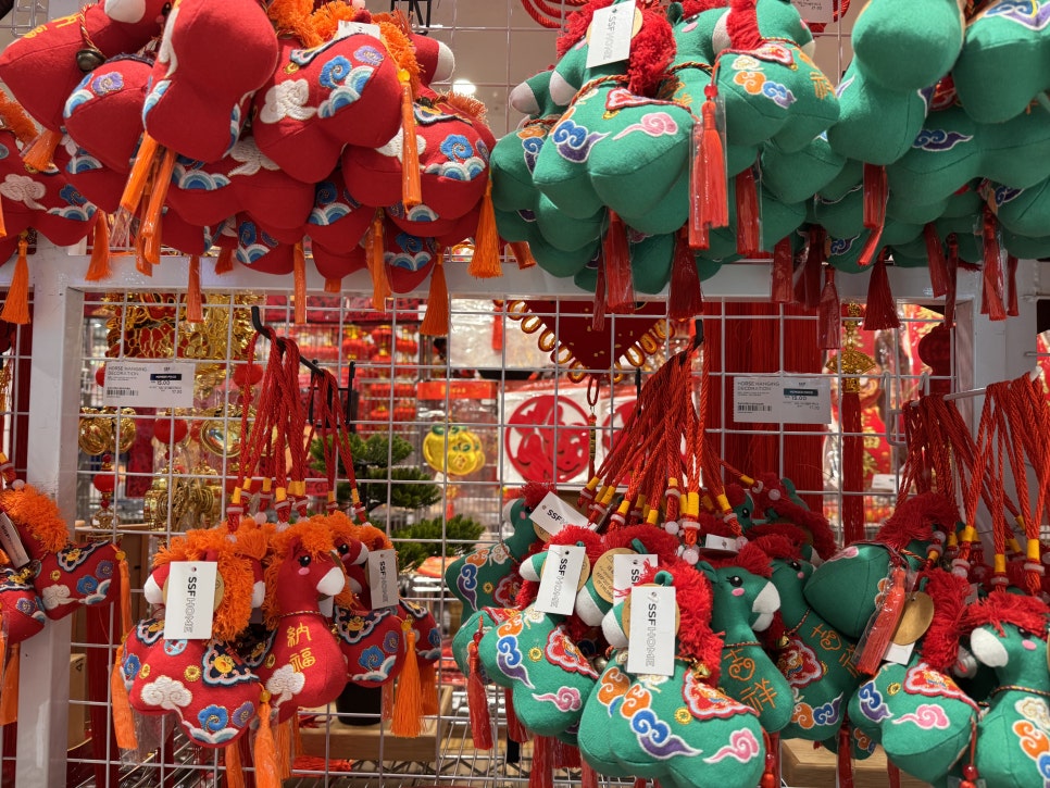 Red and green Chinese zodiac horse ornaments with decorative tassels for Lunar New Year.