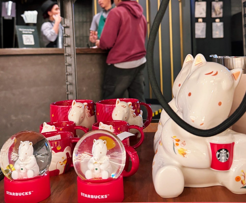 Starbucks Lunar New Year horse-themed mugs and snow globe display in Malaysia.