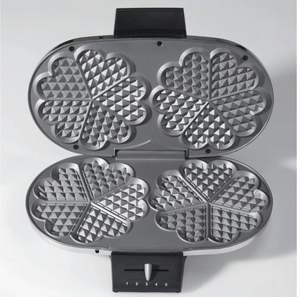 A traditional Swedish heart-shaped waffle iron open to show the five-heart pattern.